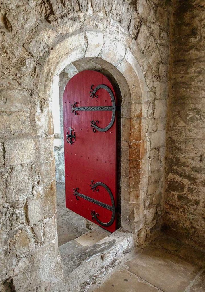 Antique red arched door inside the castle