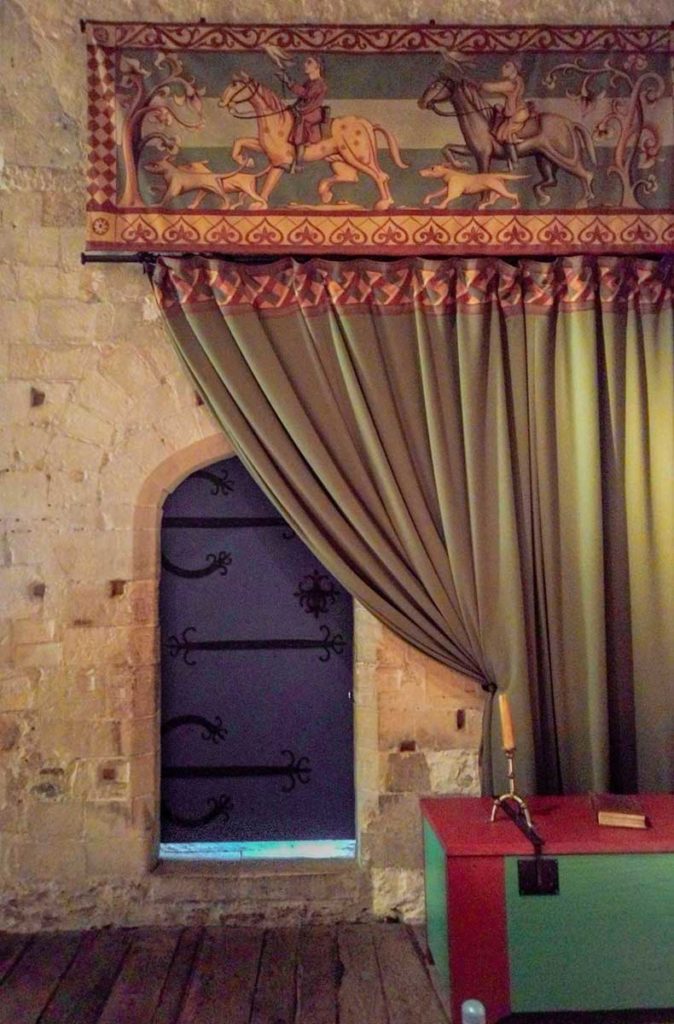 Blue arched door and green curtain at Dover castle, in Kent area at the southeast of England.