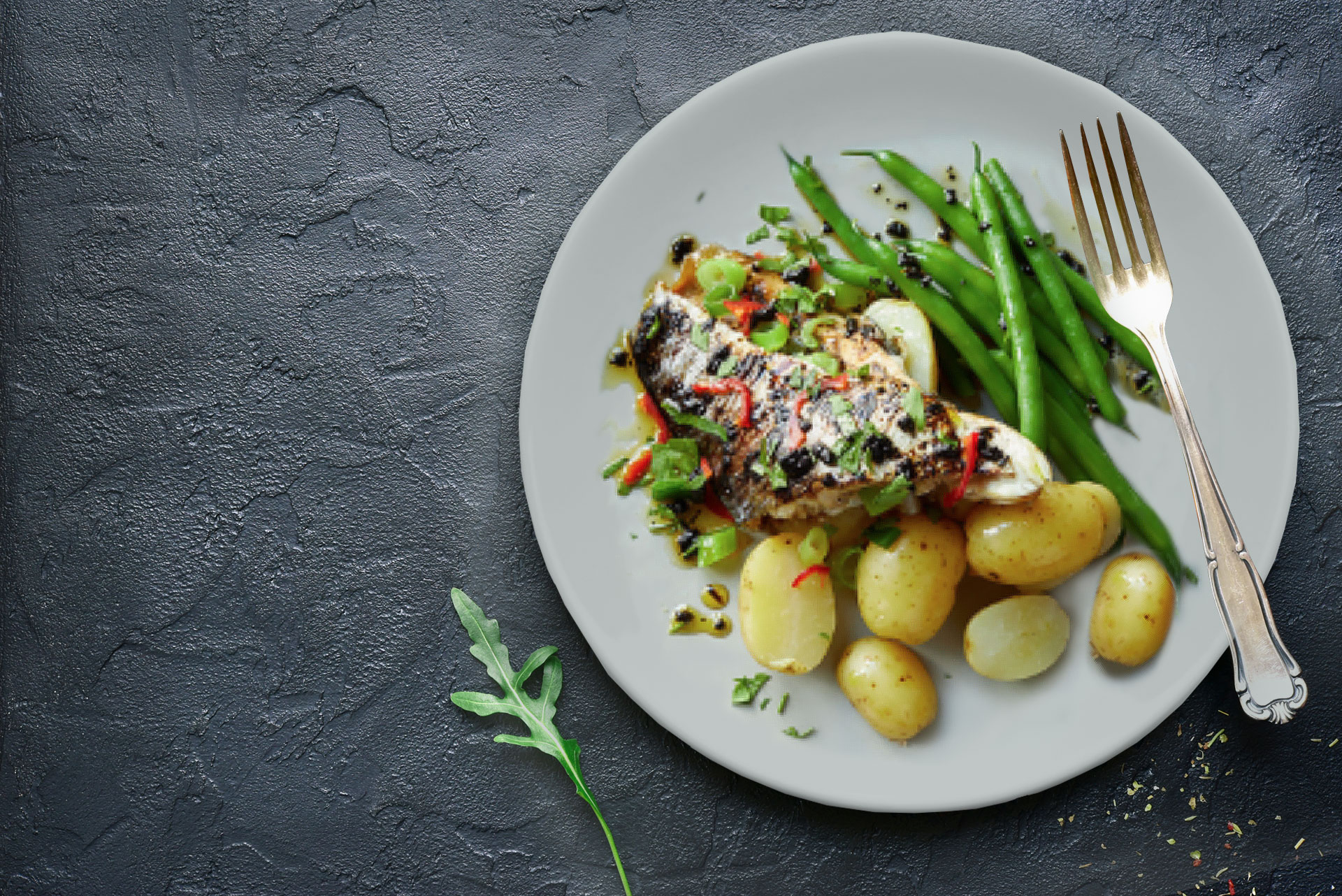 Baked sea bass with beans and potatoes