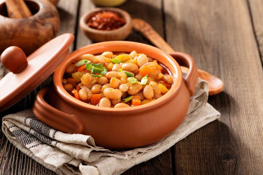 a dish of Turkish kidney beans served in a terracotta bowl