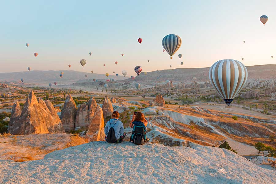 Hot air balloon flying over rock landscape at Cappadocia Turkey