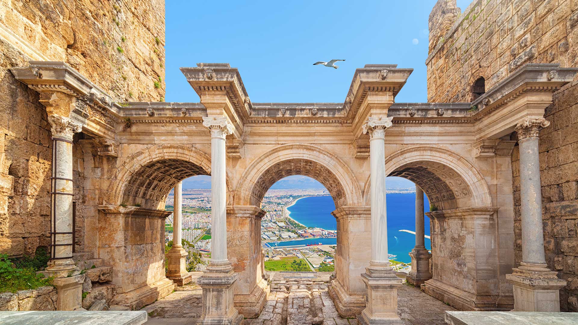 Welcome to amazing Antalya concept. Collage of famous landmarks: Hadrian's Gate old town Kaleici district and Konyaalti beach in popular resort city Antalya, Turkey