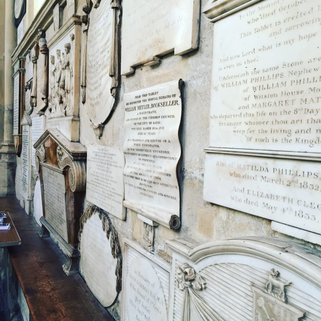 Stone scroll wall memorials in Bath Abbey