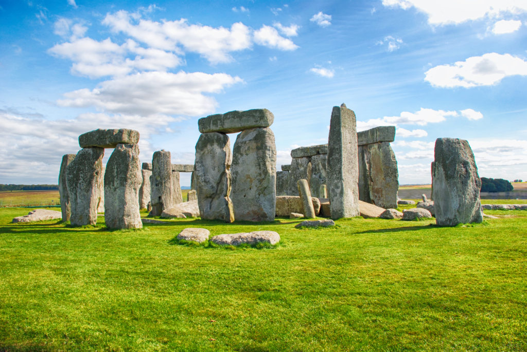 Stonehenge on a green field against a blue sky