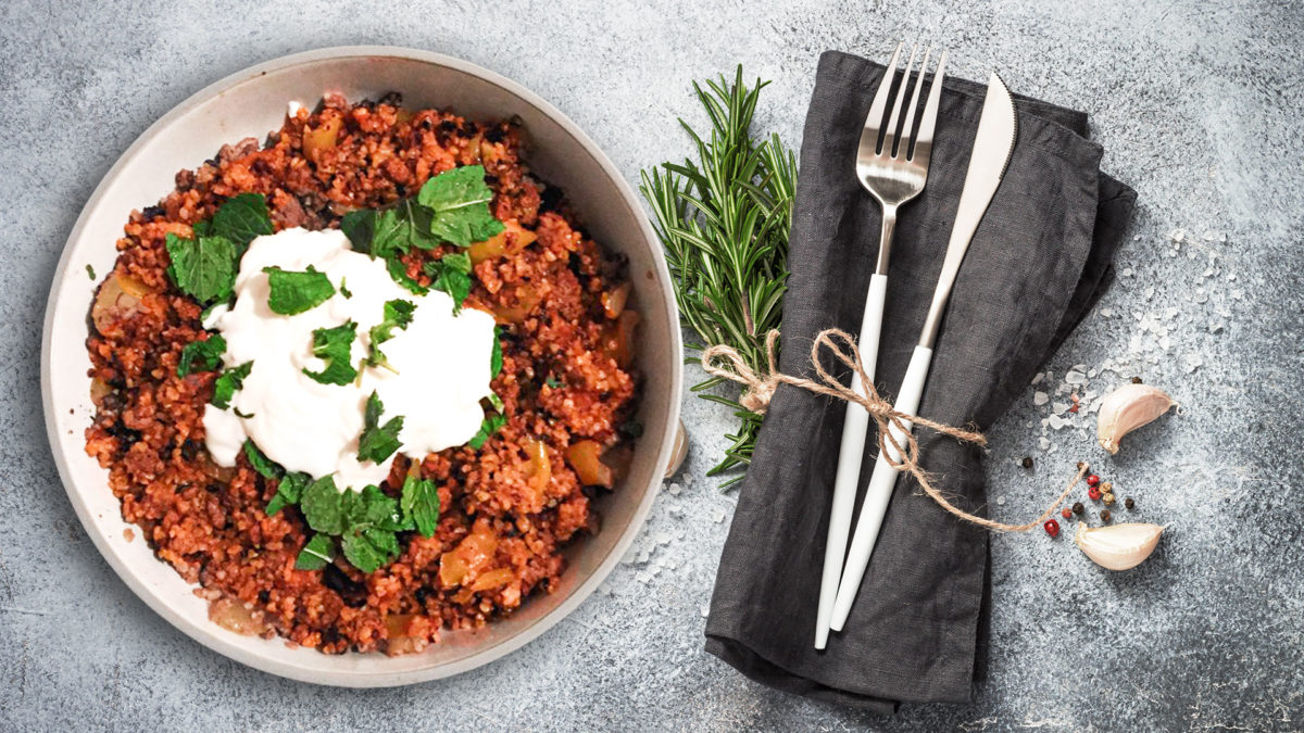 Bulgur pilaf on plate with decorated dinner table