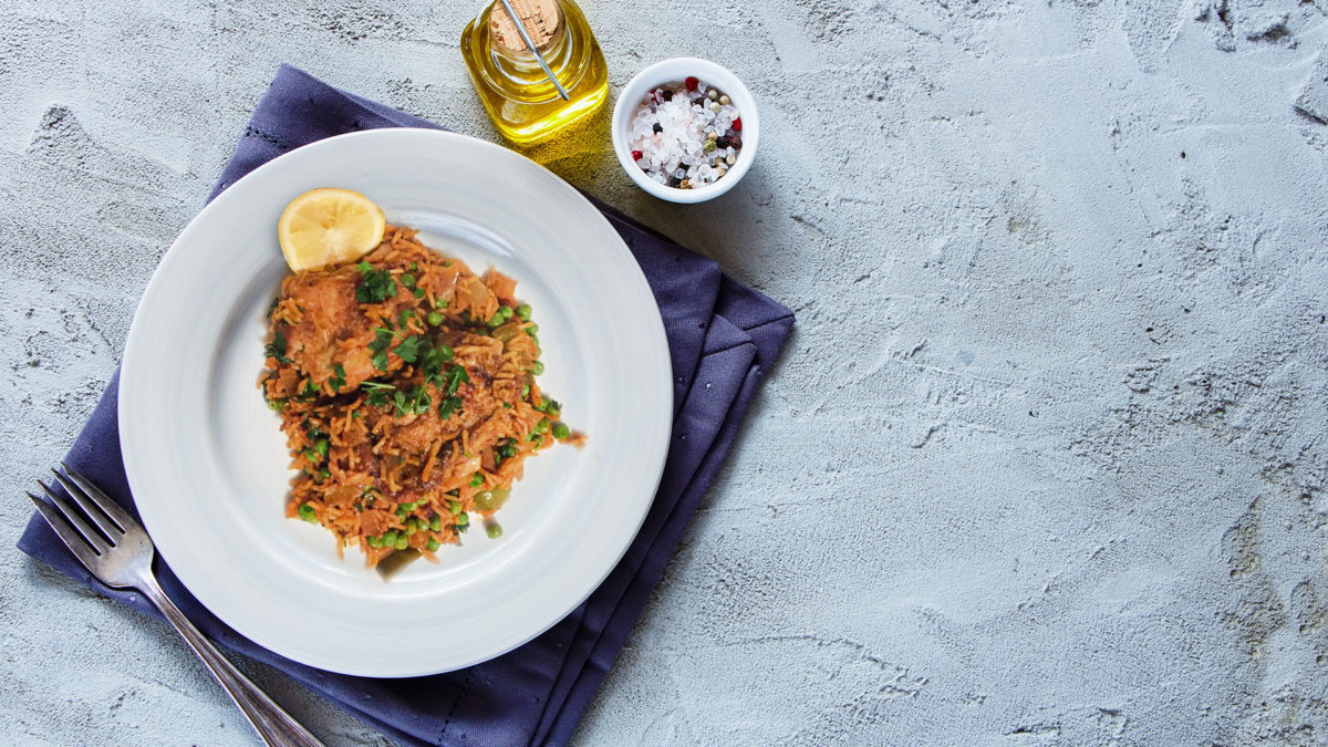 One-Pot-Brazilian Chicken & Saffron Rice on a white plate on dinner table