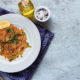 One-Pot-Brazilian Chicken & Saffron Rice on a white plate on dinner table